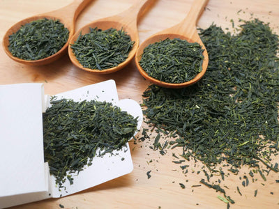 Three spoons of Japanese green tea leaves on a table