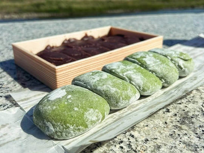 Green Mochi Next to a box of Red Bean Paste