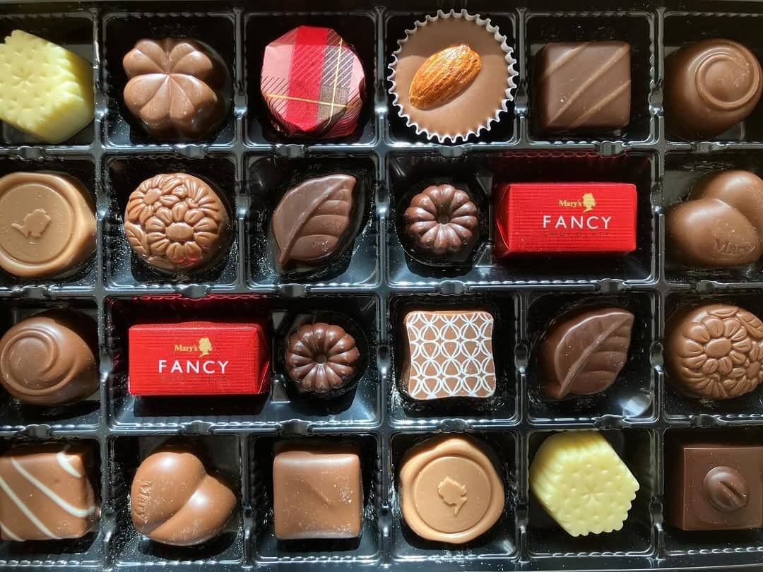A gift box full of several shapes and flavors of Japanese chocolate