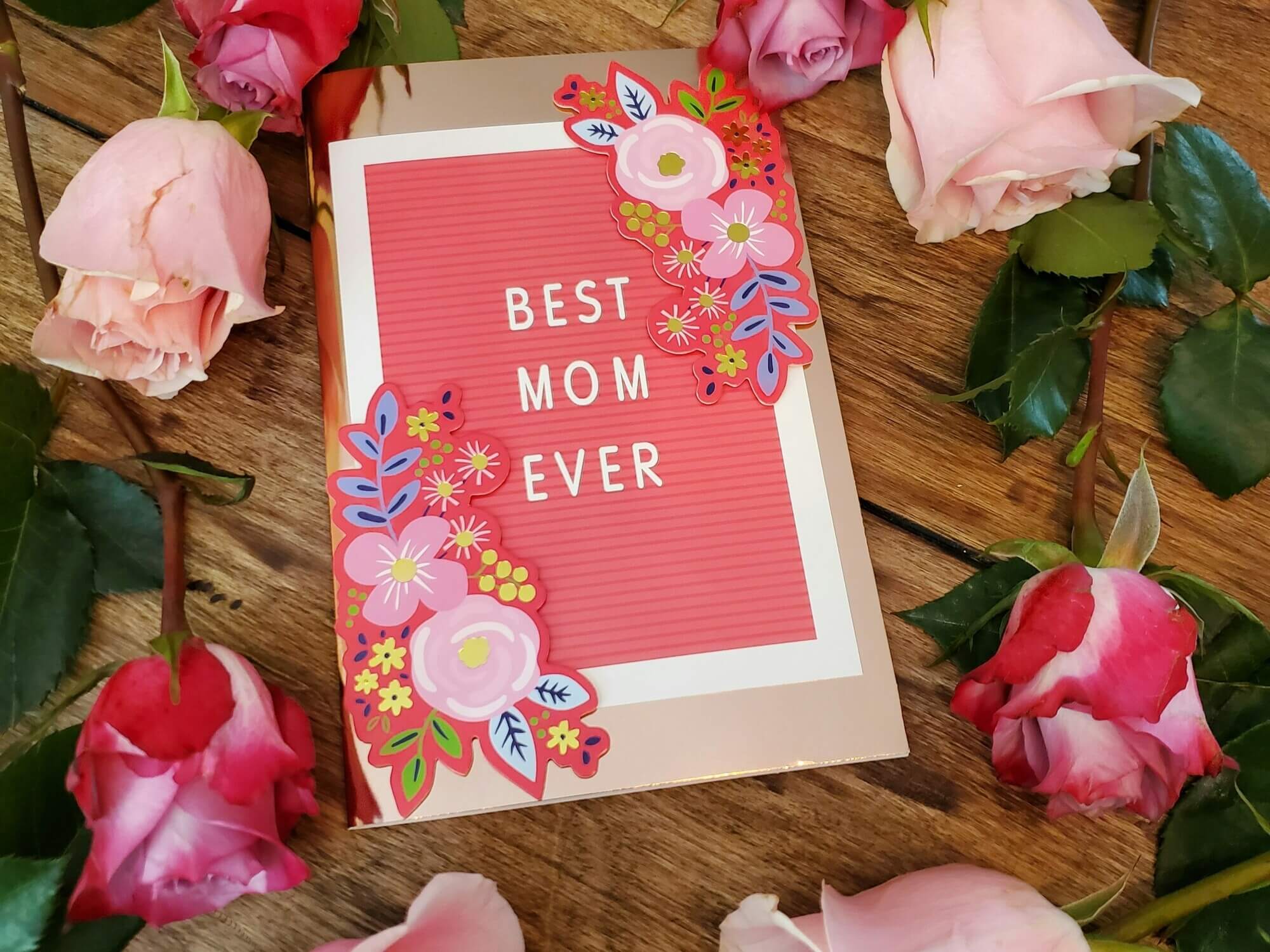 A "Best Mom Ever" card with roses surrounding it