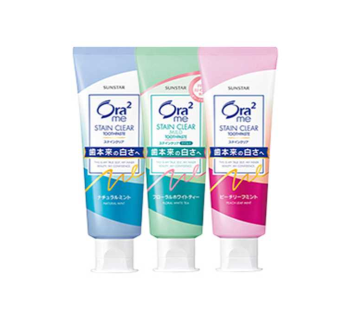 Three tubes of Ora2 Stain Clear Toothpaste in different colors on a white background